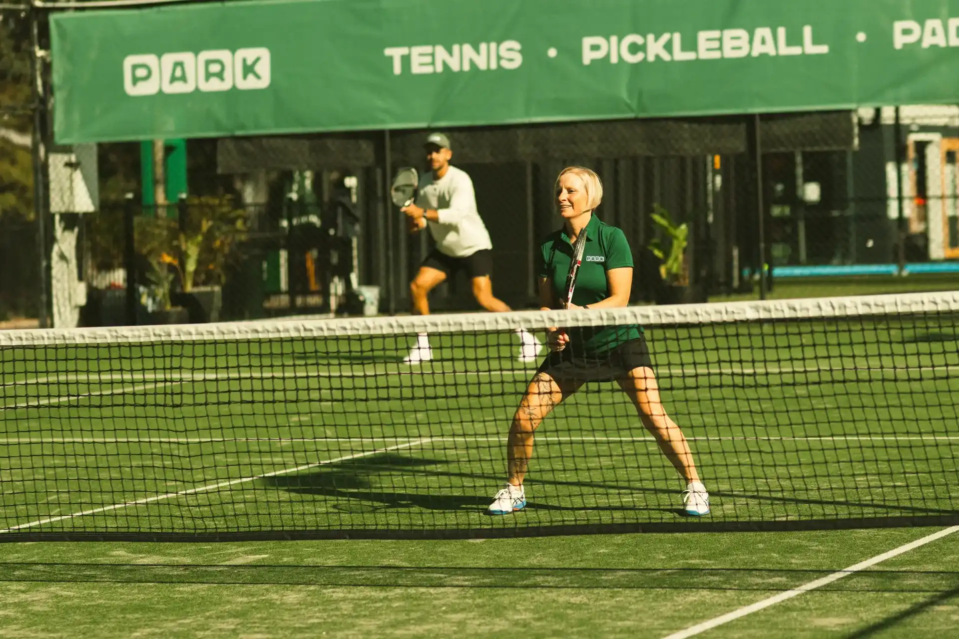 Players on the grass courts at PARK Racquet Club The Gap.